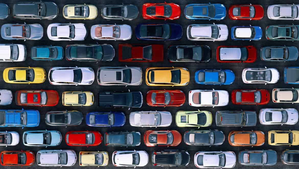 A traffic jam during rush hour, vehicles lined up in rows, top view. Cars are stuck in traffic on multiple lane city highway causing congestion, transport pollution problems in town. Transportation 3D