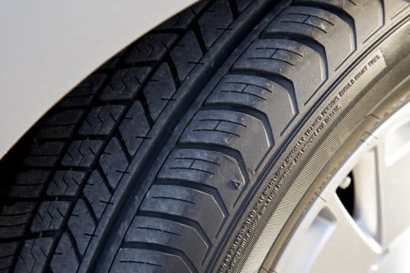 "closeup detail of the tire tread and wheel of a new, high-effiency hybrid car.Check out our other great backgrounds!"