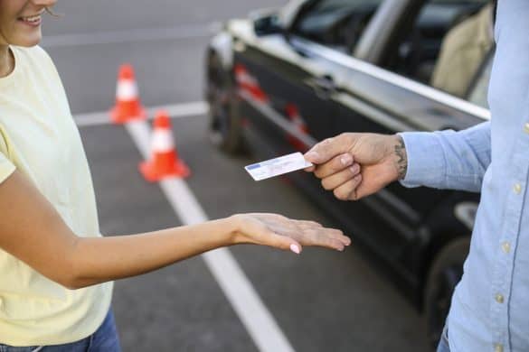 Young woman learning how to drive a car. About 20 years old, Caucasian female and a mid adult male driving instructor.